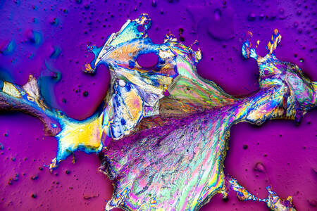 Rietsuikerkristallisatie in parfum onder een microscoop met gepolariseerd licht