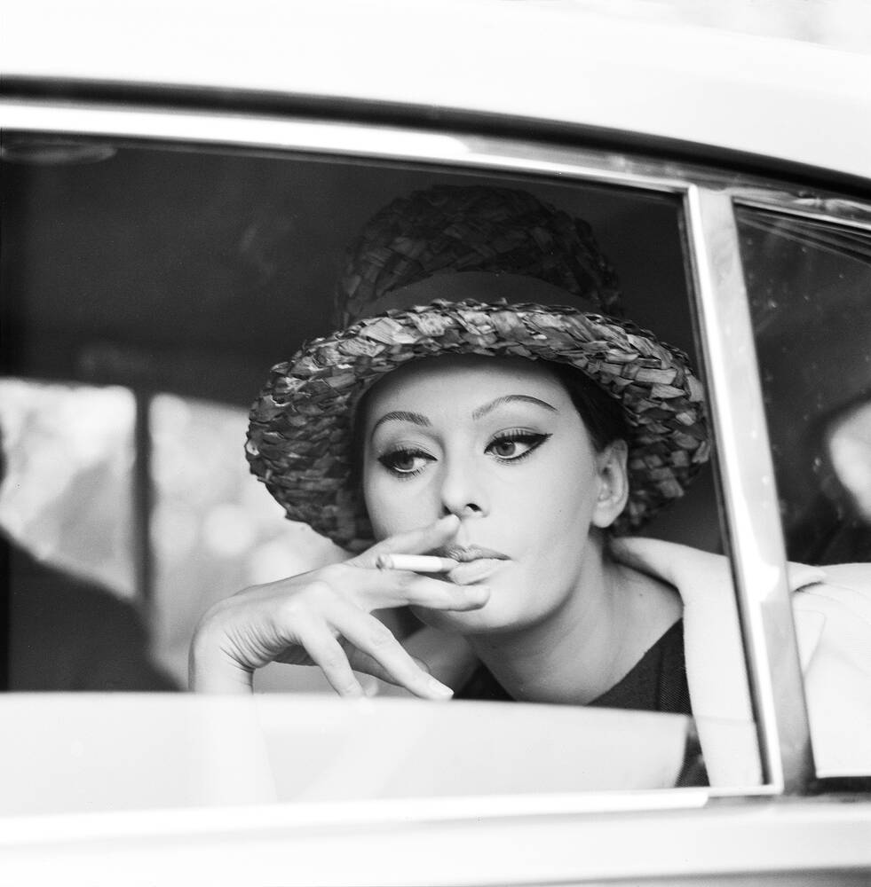 Sophia Loren smoking into a car - Photographic print for sale
