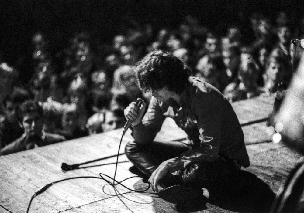 Jim Morrison zittend op het podium - Frankfurt 1968
